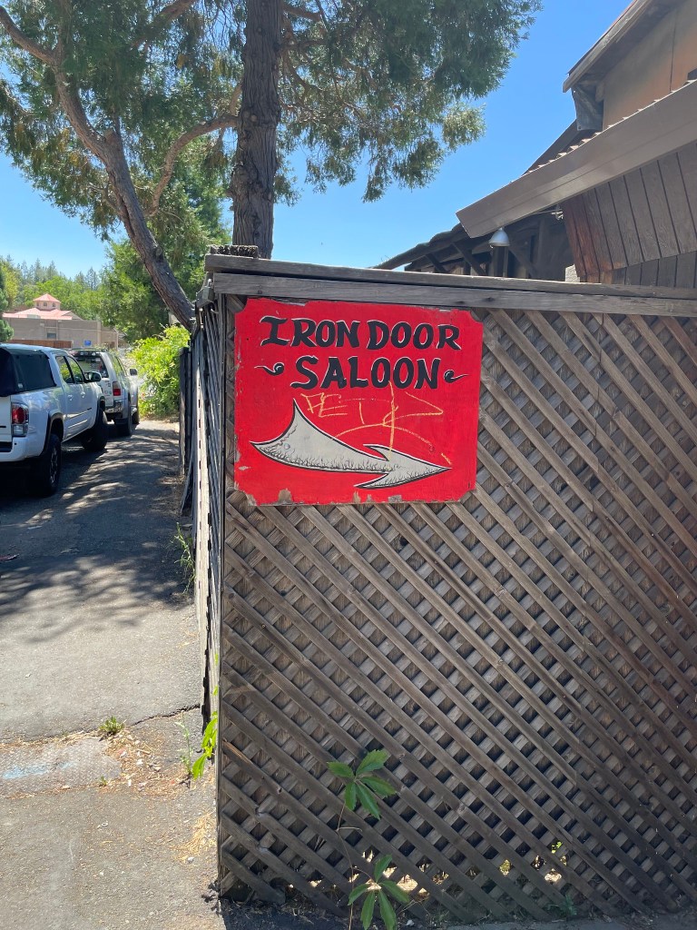 photo of sign directing to The Iron Door Saloon, Groveland, CA